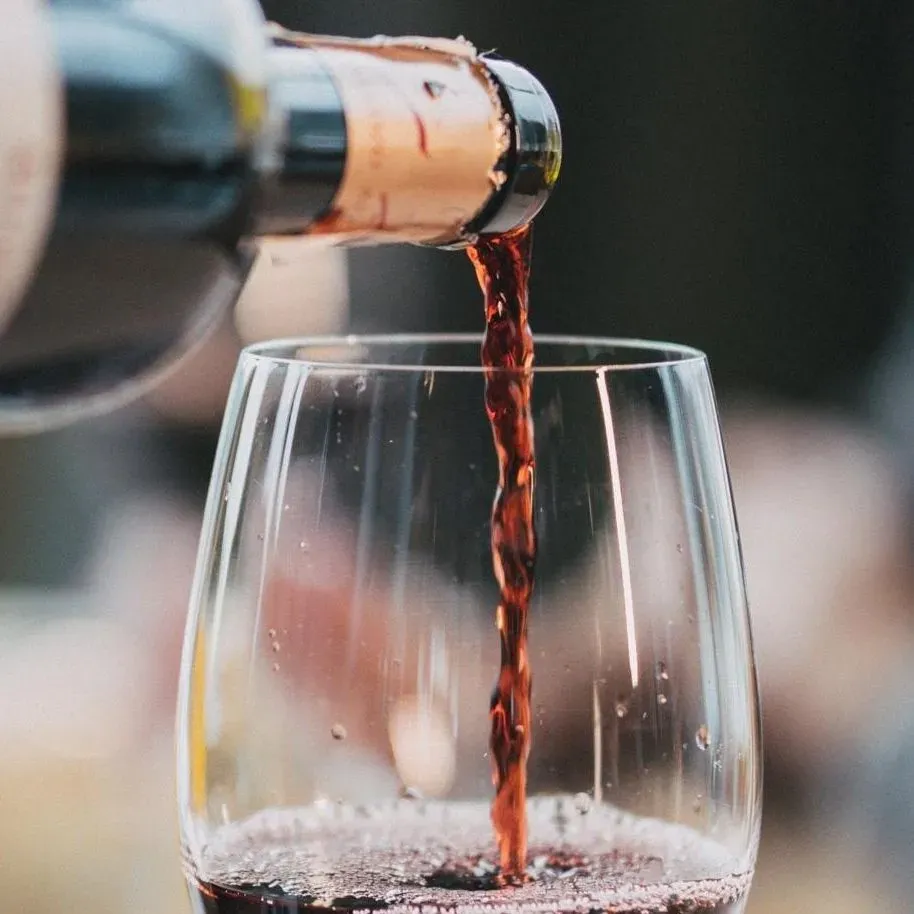 Pouring red wine into a glass in hotel restaurant
