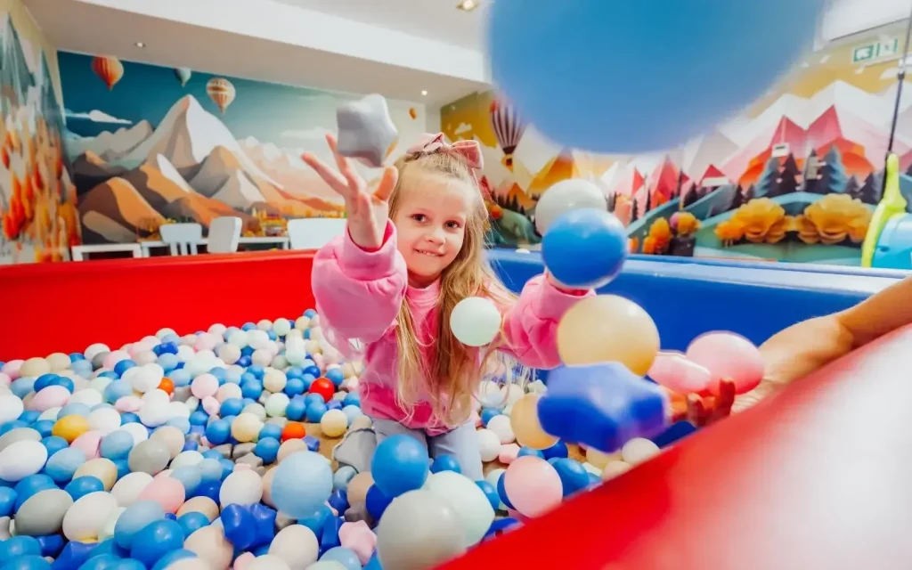 Child playing in a ball pit