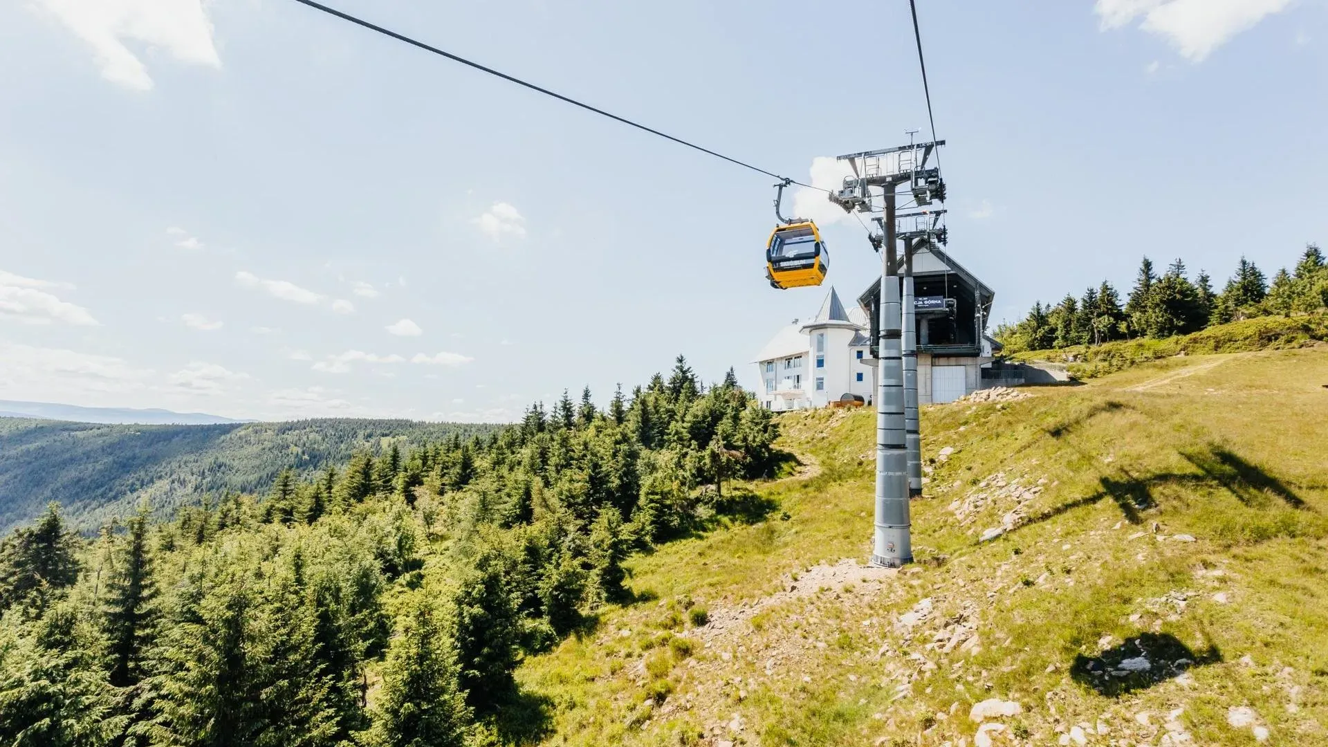 Seilbahn in den Bergen mit Blick auf Wälder und Panorama